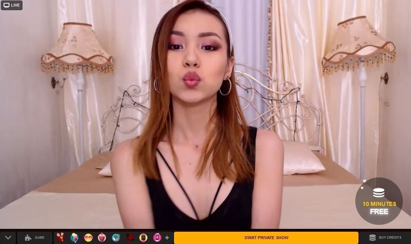 Cute young Asian model blowing a kiss on LiveSexAsian